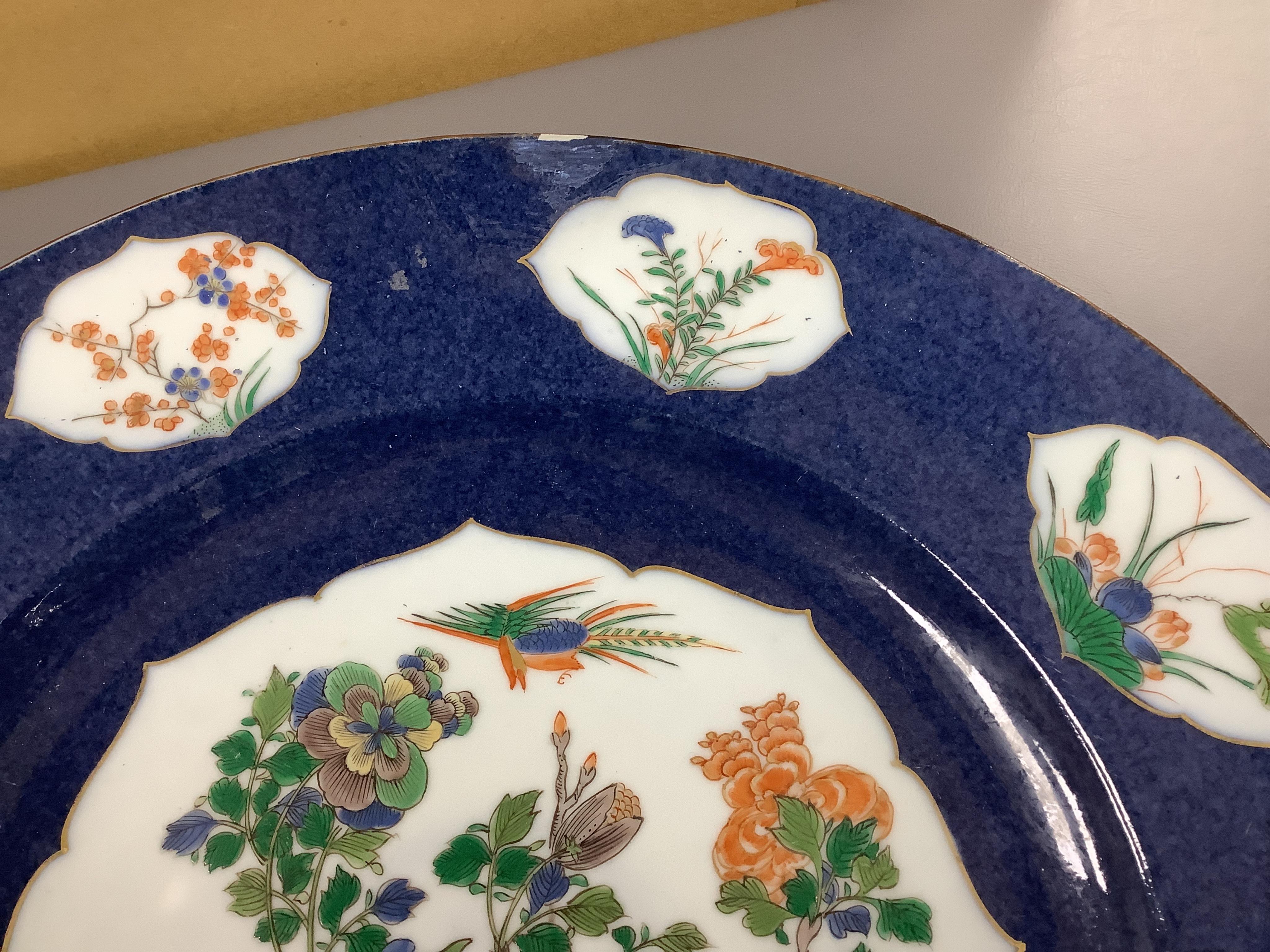 A near pair of Samson famille verte powder blue dishes in Chinese export style, each painted with a pheasant flying above blossoming branches and rocks, the border set with eight floral cartouches, underglaze blue ribbon